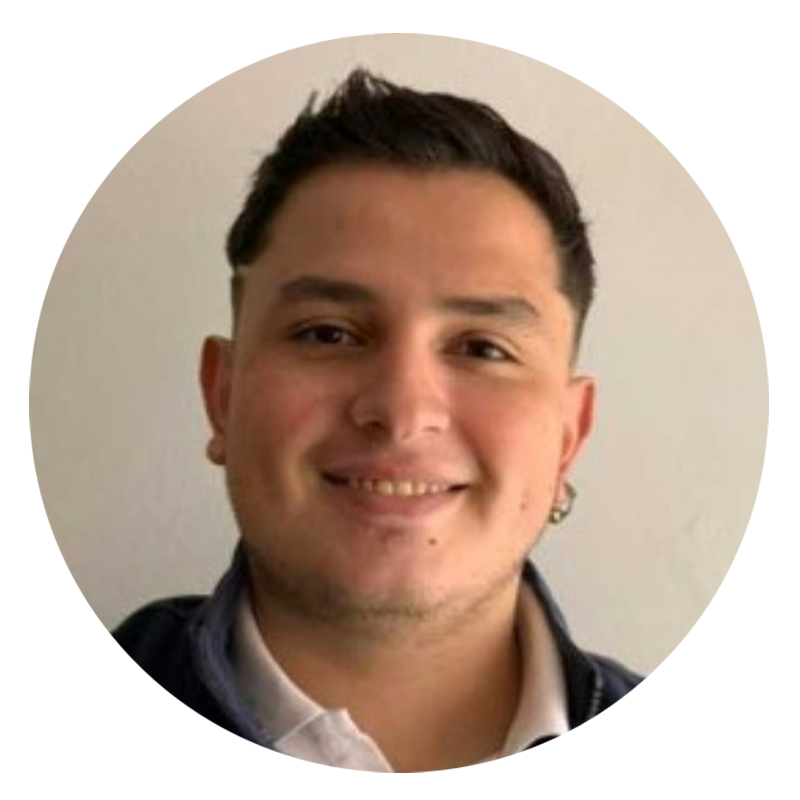 Smiling man with short hair and earrings.